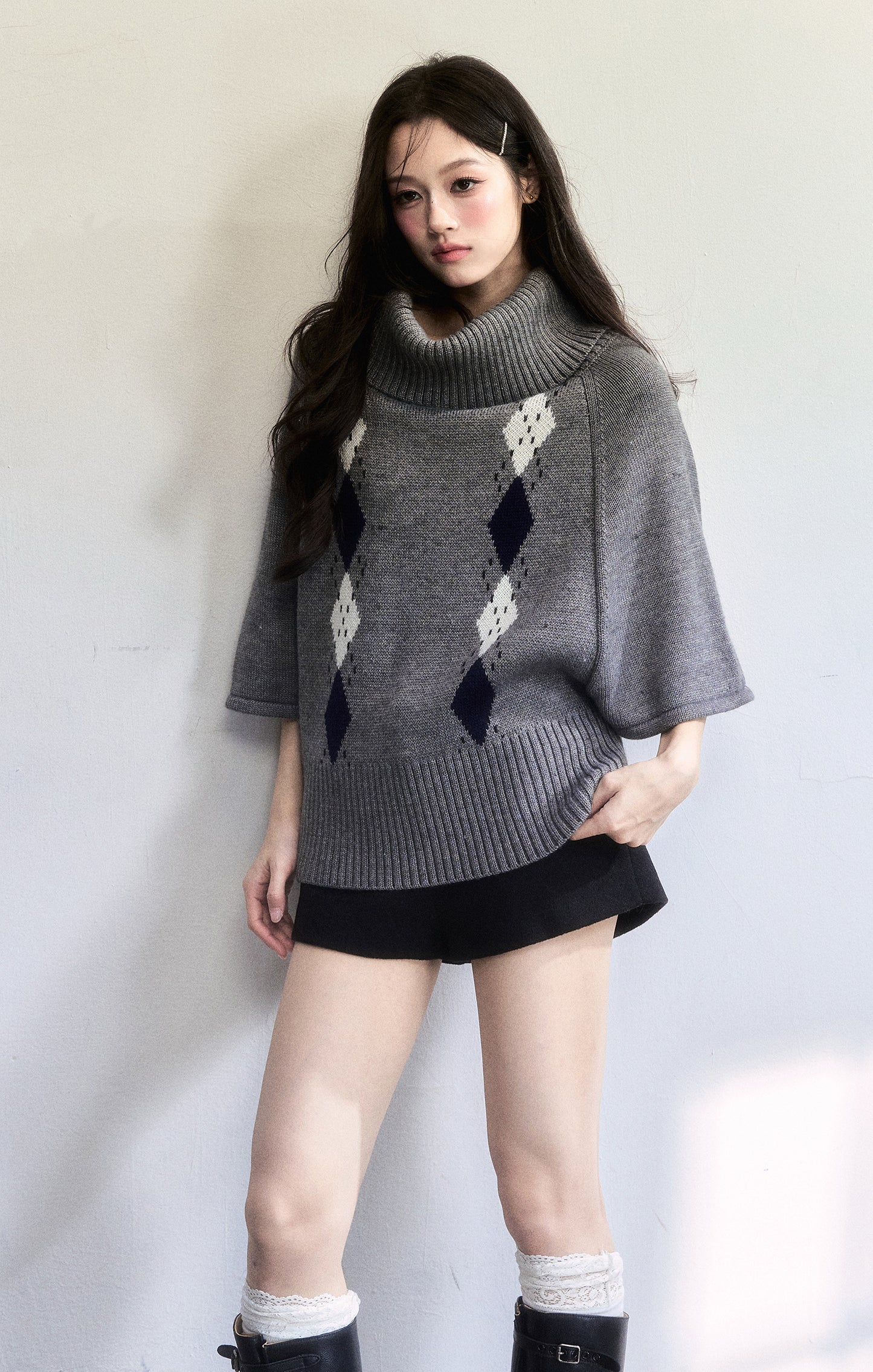 Cape-Inspired Roll Neck Argyle Knit Top